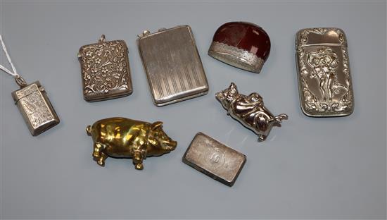 A small collection of eight assorted vesta cases including three silver, one white metal and four base metal including two pig vestas.